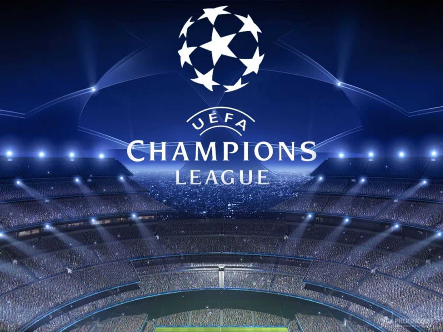 UEFA Champions League logo displayed over a packed stadium at night.